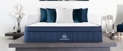 Brooklyn Bedding Aurora hybrid mattress. The Aurora laying on a platform bedframe in a bedroom with pillows and side tables.