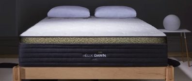 Helix Midnight Luxe Mattress on a natural wood platform bedframe with pillows in a bedroom