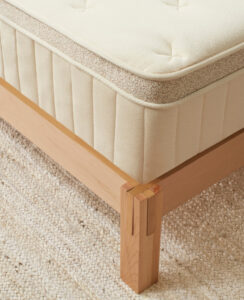 Corner of the birch luxe mattress on a bed frame showing the strength of its edge support