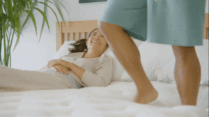 GIF of man walking on Owl with woman laying down